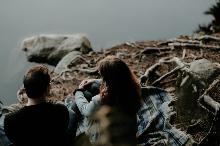 Couple sitting by river