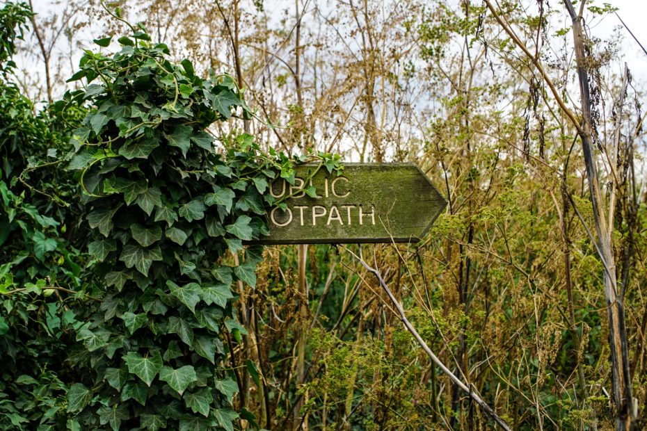 Overgrown public footpath sign