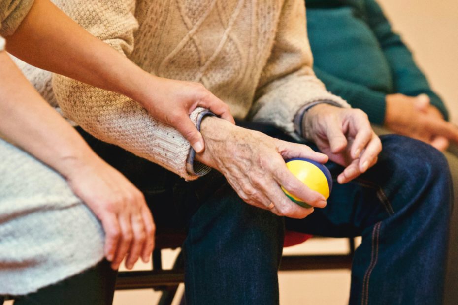 Old man holding a ball